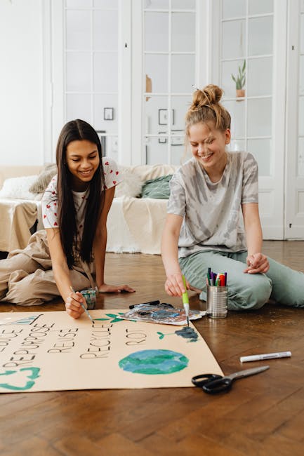 Two teenagers collaborate on an eco-friendly painting project indoors.