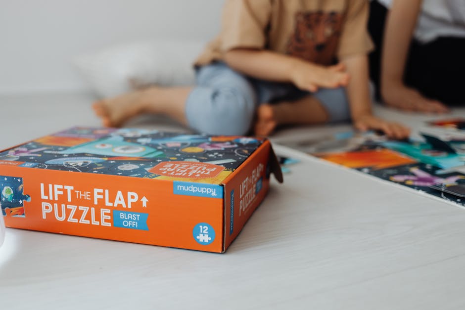 Close-up of children playing a fun and educational lift the flap puzzle game indoors.