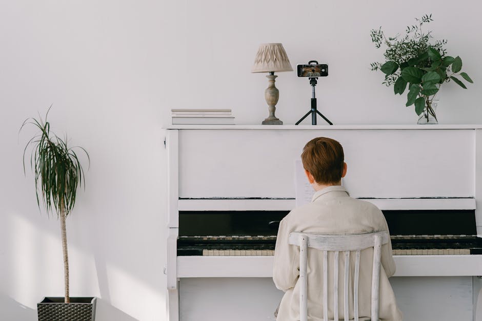 A boy playing piano indoors, capturing a serene moment of musical concentration.